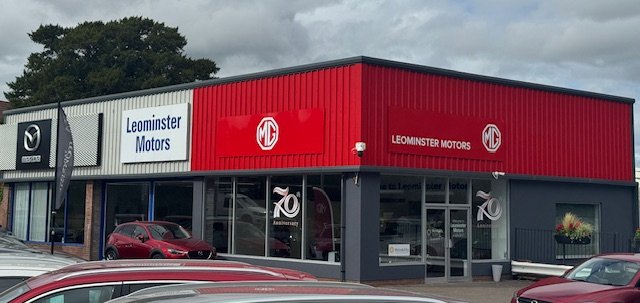 Exterior of Leominster Motors dealership with MG and Mazda signage.